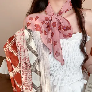 Detail view of vintage printed chiffon neck scarves with floral and striped patterns