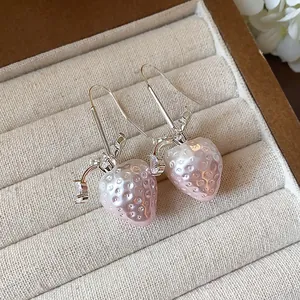 Detailed close-up of sweet pink strawberry drop earrings with sparkling zircon accents