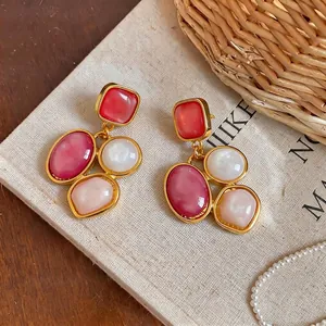 Vintage palace style geometric resin oval drop earrings in red and pink gold finish.