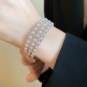 Elegant triple layer white pearl bracelet with sparkling rhinestone spacers for women