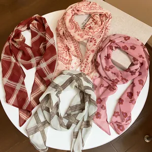 Assorted vintage chiffon scarves featuring floral and plaid prints in soft colors