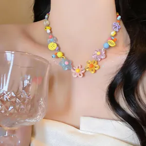 Close-up of colorful daisy bead necklace with vibrant floral and bow charms.