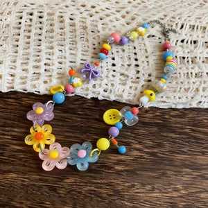 Detailed view of colorful dopamine necklace with acrylic flower and mushroom charms