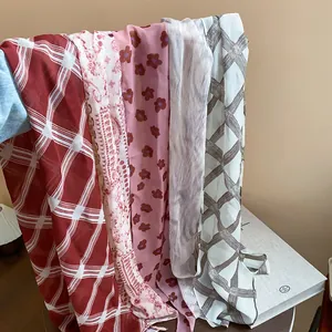 Detailed view of various vintage print chiffon scarves showing texture and patterns