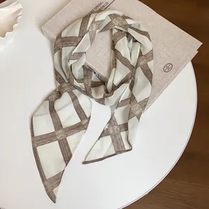 Macro view of vintage brown and white checkered print chiffon scarf accessory
