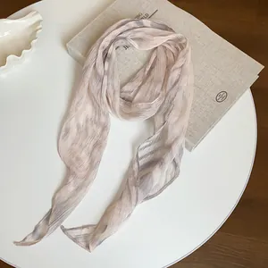 Elegant texture of a vintage striped chiffon neckerchief on a linen book background