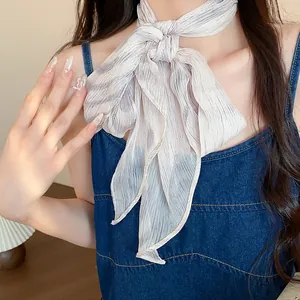Detailed view of a vintage pleated chiffon neck scarf elegantly tied on a model