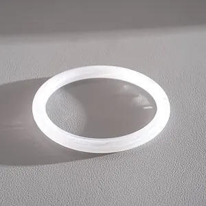 Detail showing a white marbled acrylic oval geometric bangle with minimalist aesthetic