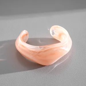 Detailed view of a pink marbled acrylic irregular geometric cuff bangle for women