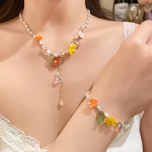 Elegant candy-colored beaded flower necklace and bracelet jewelry set worn by a model