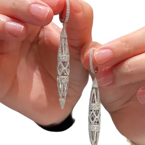 Elegant retro silver hollow spindle drop earrings with sparkling stones in a palace style
