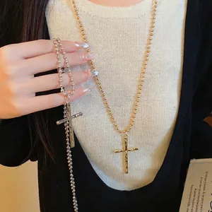 Vintage gold and silver metal cross pendant necklaces with elegant bead chains on model