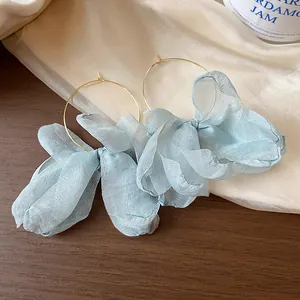 Close-up of light blue organza flower petals on gold hoop earrings for women