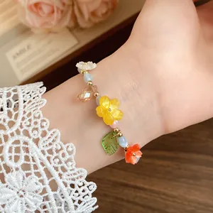 Detailed view of candy-colored beaded bracelet with vibrant flower and leaf charms