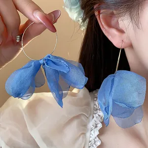 Detailed close-up of sweet blue floral hoop earrings with elegant fabric petals