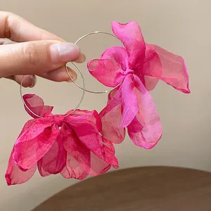 Large fuchsia oversized organza bow hoop earrings for a sweet and elegant vacation style