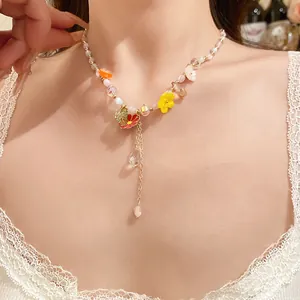 Close-up detail of candy-colored beaded necklace with cute floral charms on a model