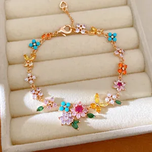 Detailed view of 18k gold plated bracelet featuring colorful zircon flowers and pearls.