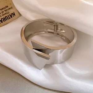 Elegant minimalist silver geometric wide metal bangle with polished mirror finish