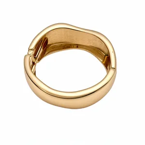 Minimalist polished gold wavy bangle bracelet with a high-end fashion irregular design