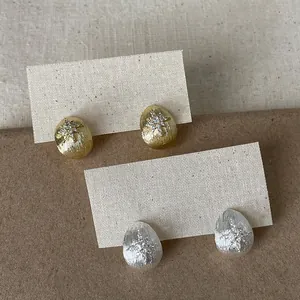 Macro view of 18k gold and silver plated waterdrop earrings with zircon star details