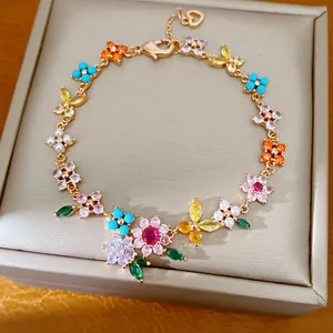 Detailed macro view of 18k gold plated bracelet with colorful zircon and pearl flowers