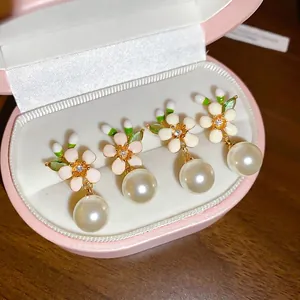 Elegant enamel flower stud earrings with hanging pearls in a gift box