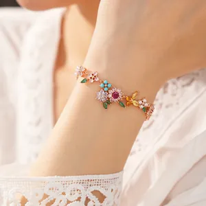 Detailed macro shot of a colorful floral zircon bracelet with pearls on a woman's wrist