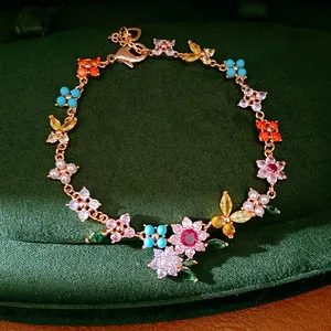 Detailed view of the 18k gold plated bracelet with colorful zircon flowers and pearls