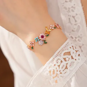 Close-up of elegant 18k gold plated bracelet with colorful floral zirconia and pearls