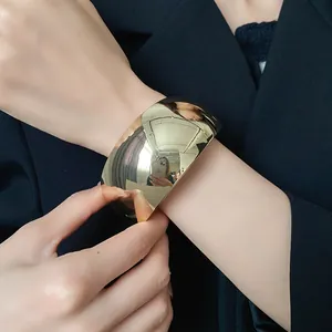 Wide glossy gold cuff bracelet for women, minimalist mirror finish bangle jewelry detail