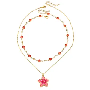 Double layer gold chain necklace with pink enamel flower pendant and red crystals