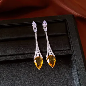 Elegant close-up of vintage yellow teardrop earrings with white zirconia accents
