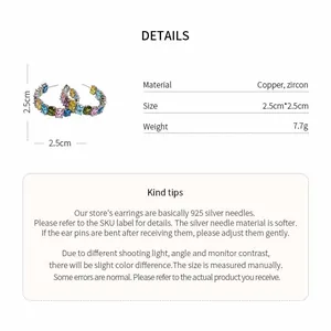 Detail view of colorful C-shaped zircon earrings with size and material specifications