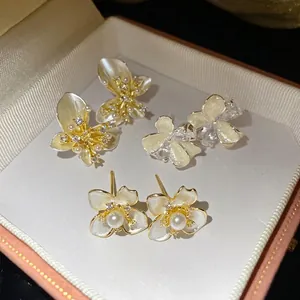 Elegant white pearl and flower drop stud earrings with sparkling cubic zirconia stones