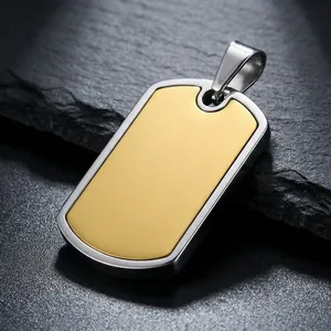 Detail view of a two-tone stainless steel dog tag pendant on a dark slate surface.