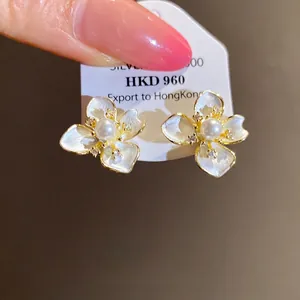 Elegant white flower stud earrings with central pearls and sparkling zircon accents for women