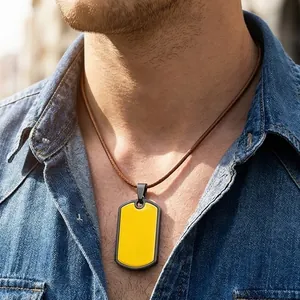 Close-up of a minimalist yellow stainless steel dog tag necklace worn on a brown cord