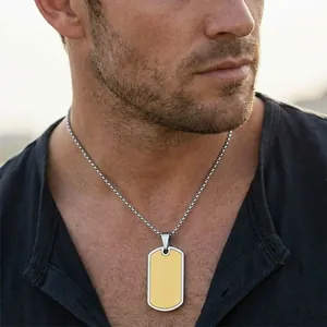 High-quality close-up of a two-tone stainless steel dog tag necklace worn by a male model.