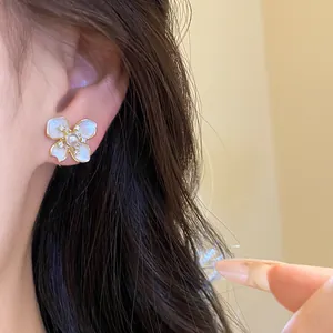 Detailed macro view of an elegant white flower stud earring with pearl and zircon