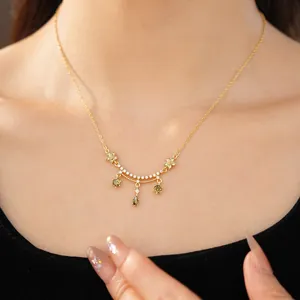 Close-up of 18k gold plated zircon necklace with flower and water drop pendants