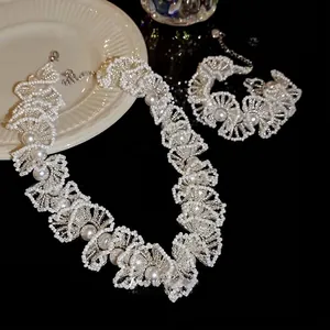 Detail shot of a French luxury beaded pearl necklace with ruffled design and silver clasp