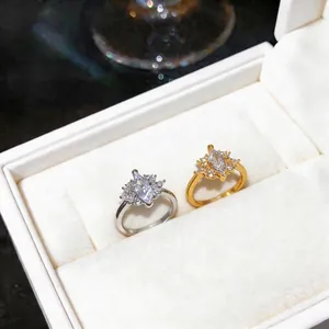 Elegant marquise-cut zircon ring set in gold and silver finishes displayed in a box