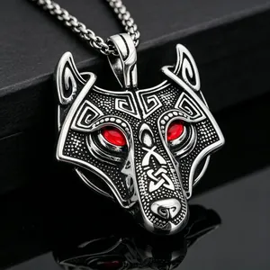Detailed close-up view of a Norse wolf head pendant in stainless steel with red eyes