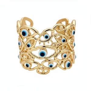Bracciale rigido vintage dorato a occhio di bue traforato con dettagli in smalto blu