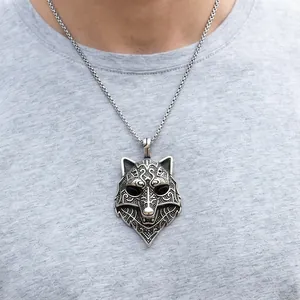 Detailed view of a vintage stainless steel wolf head pendant with Nordic engravings.