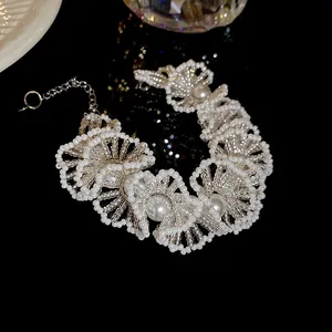 Close-up of elegant French style beaded pearl necklace with intricate floral patterns