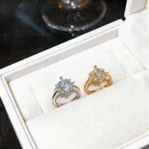 Detailed view of exquisite silver and gold marquise zircon rings inside a white velvet box