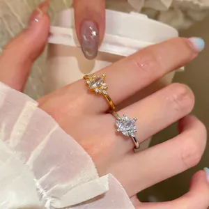 Close-up of gold and silver minimalist marquise zircon rings in a lifestyle setting