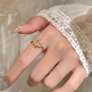 Detailed view of an elegant gold ring with a marquise-cut zircon on a woman's finger